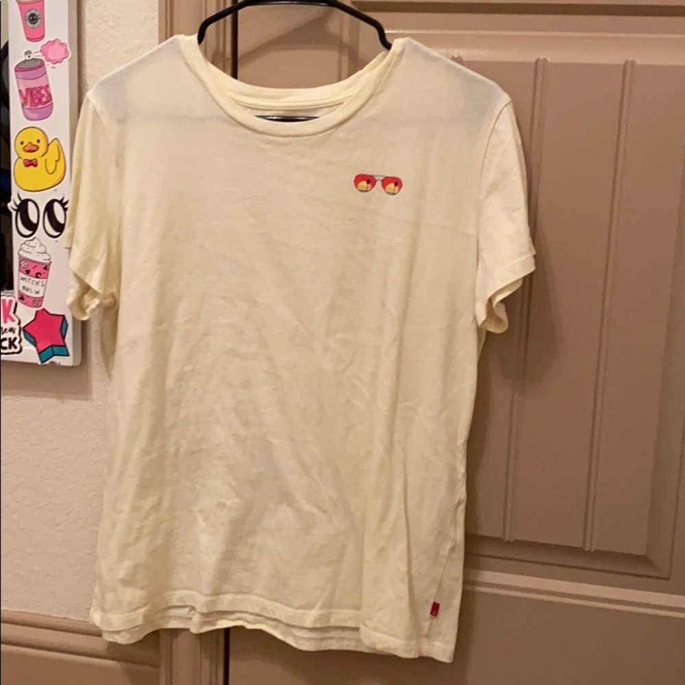 yellow levis top with sunglasses on the front